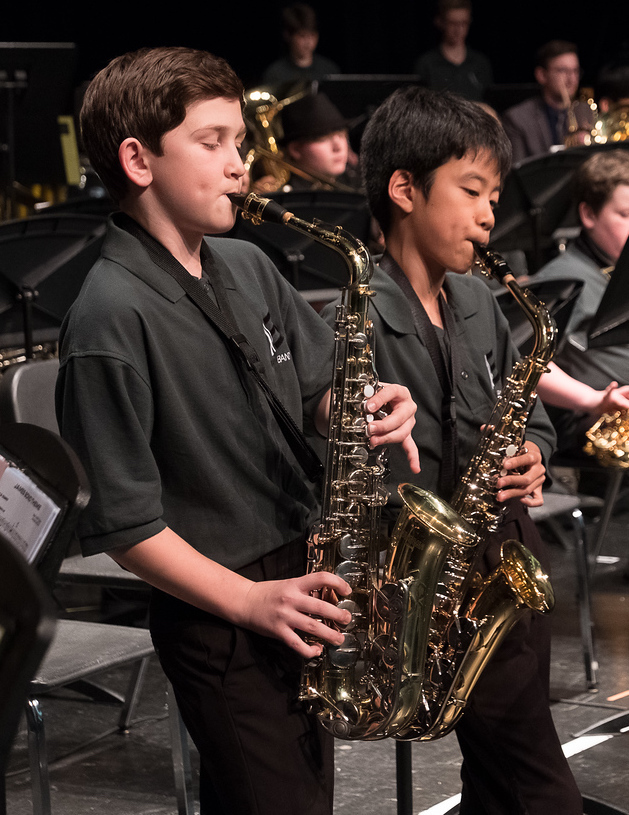 three kids playing instruments